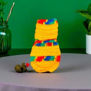 Colorful crocheted plastic grocery bag holder. Yellow striped with blue green